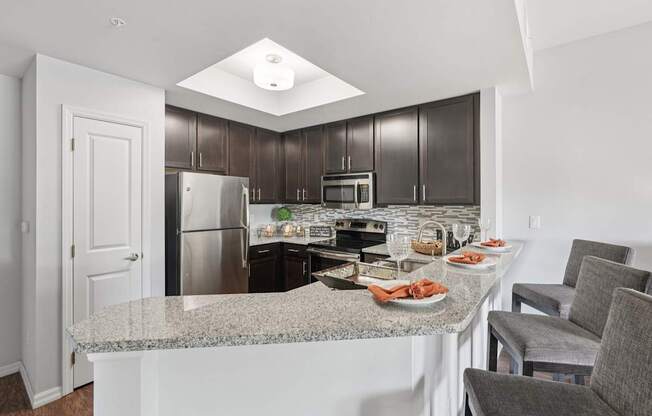 A kitchen with a granite countertop and a breakfast spread.