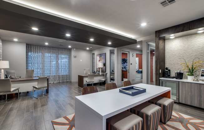 a spacious room with a white table and chairs
