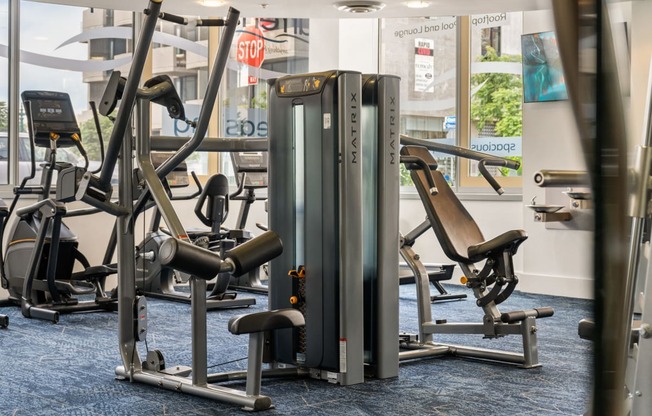 a row of exercise machines in a gym