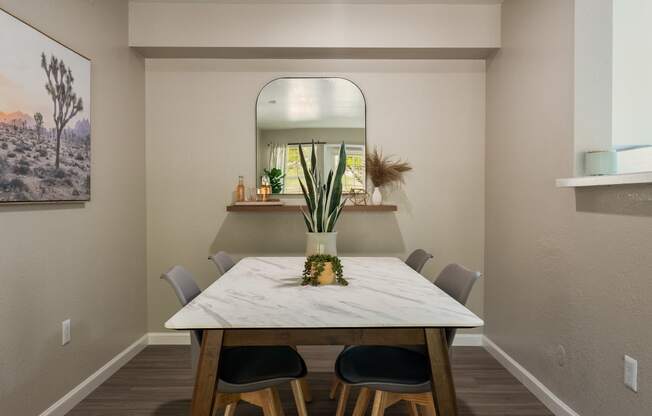 a dining room with a table and chairs at Odyssey Ridge, Albuquerque, 87114