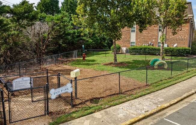 a dog park in front of a brick building
