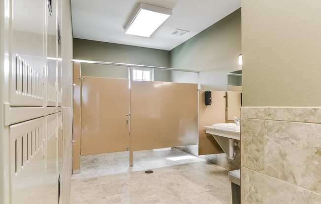 a public bathroom with frosted glass doors