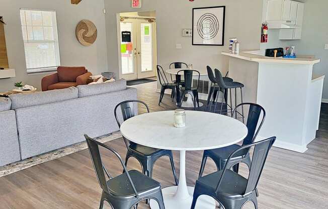 a dining room and living room with a table and chairs