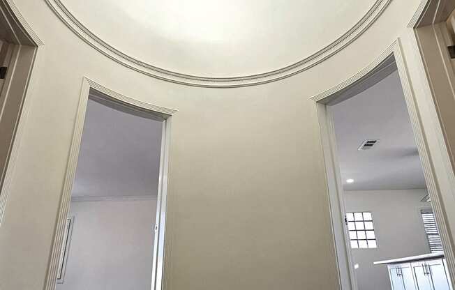 a view of a hallway with a large ceiling and a chandelier