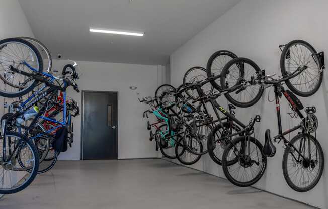 a group of bikes hanging on a wall in a room
