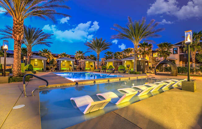 A pool with a slide and a sun lounger.