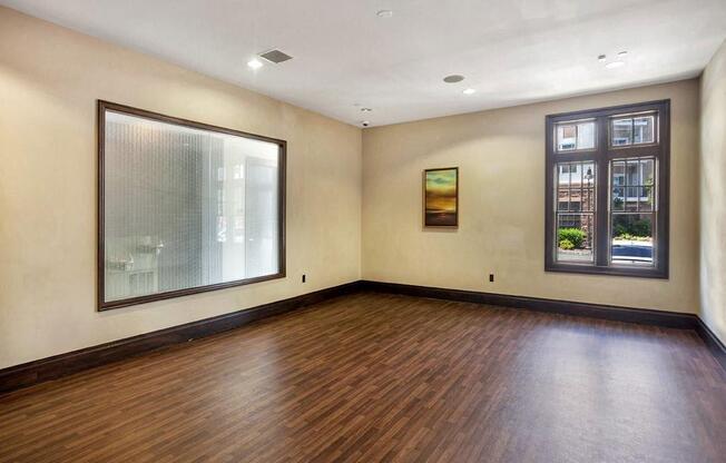 A room with wooden floors and a large mirror on the wall at Vermella Lyndhurst apartments, Lyndhurst 07071