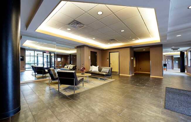 A spacious lobby with a seating area and a large mirror.
