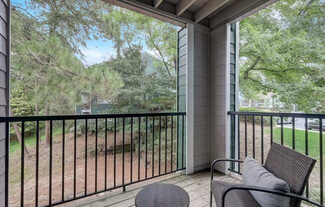 a private balcony with a view of a yard and trees at Wynnwood Vinings Atlanta