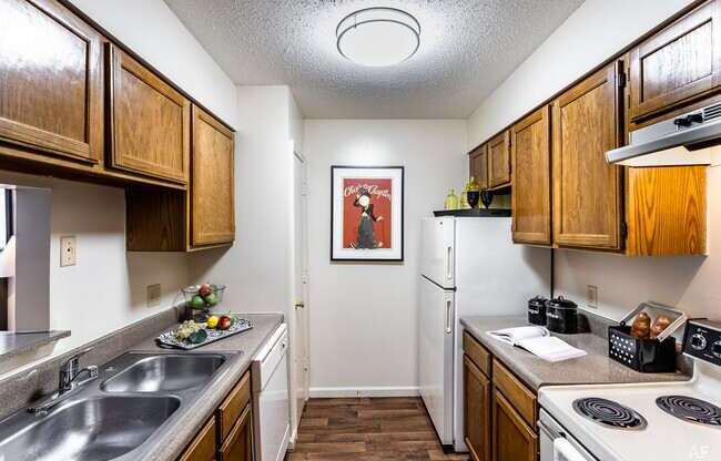 A kitchen with wooden cabinets and a white refrigerator.