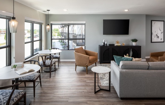 a living room with a couch and tables and a television