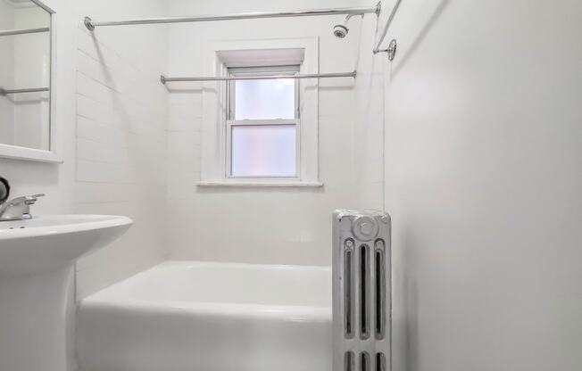 a bathroom with a tub and a sink