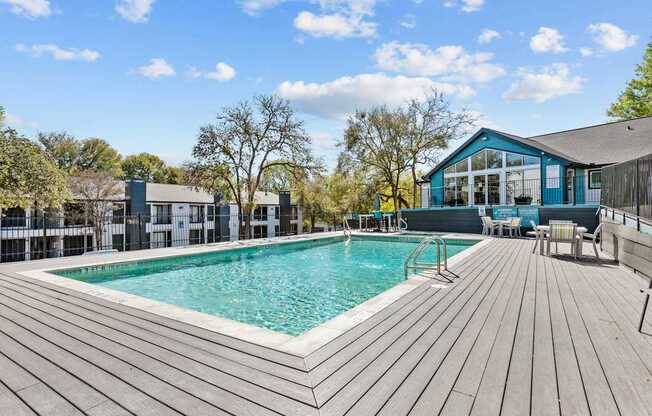 a swimming pool with a house in the background