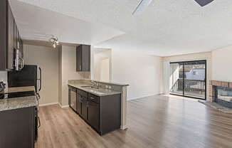 A kitchen with dark wood cabinets and a black stove top oven.