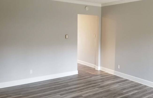bedroom with wooden floors and neutral walls