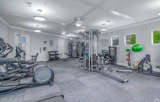A spacious gym with a variety of equipment including treadmills, weights, and exercise machines.