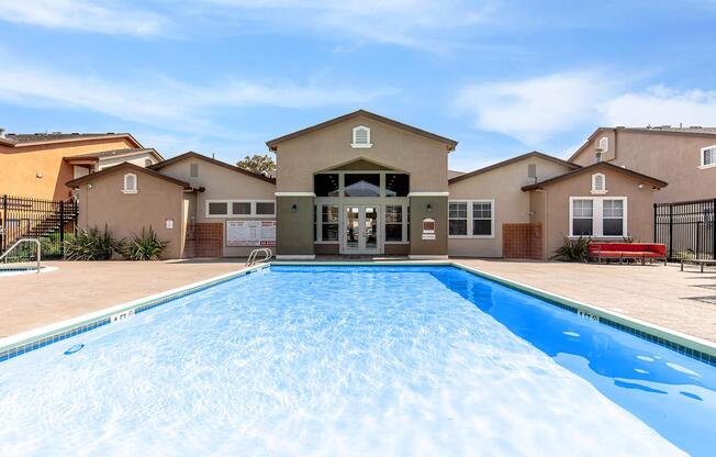 a house with a pool in front of a building