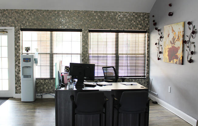 a home office with a desk and chairs