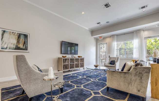 A living room with a grey chair and a brown sofa.