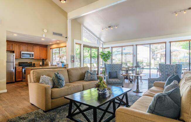 A living room with a beige couch and a black coffee table.