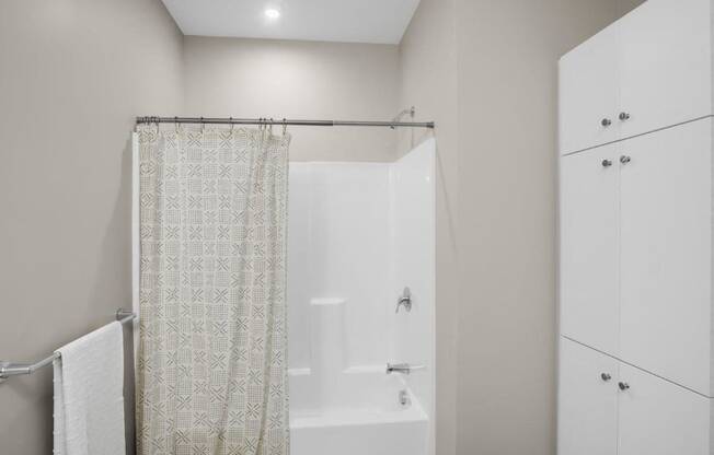 a bathroom with a shower and a shower curtain