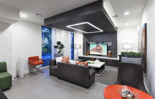 a living room with black and white walls and a tv on the wall