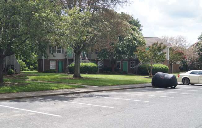a black trash bag in a parking lot in front of a house