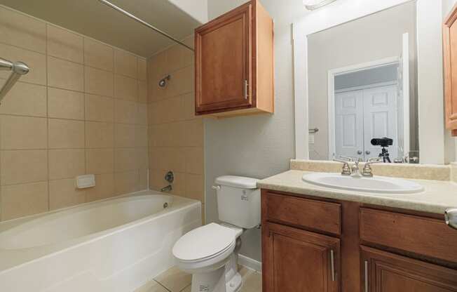 a bathroom with a sink toilet and a bath tub