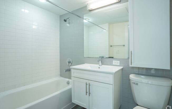 A white bathroom with a tub, sink, and toilet at 603 Concord Apartments, Cambridge