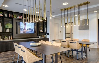 a dining room with a table and chairs and a tv