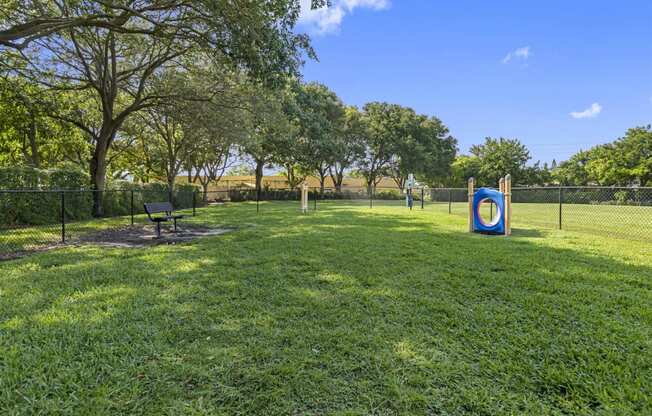 a park with a playground and a target on the grass