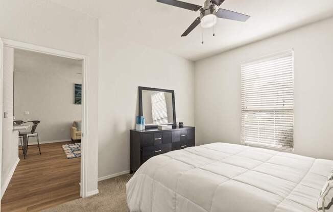 a bedroom with a large bed and a ceiling fan