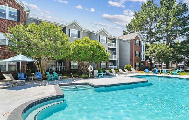 A swimming pool in front of a residential building.