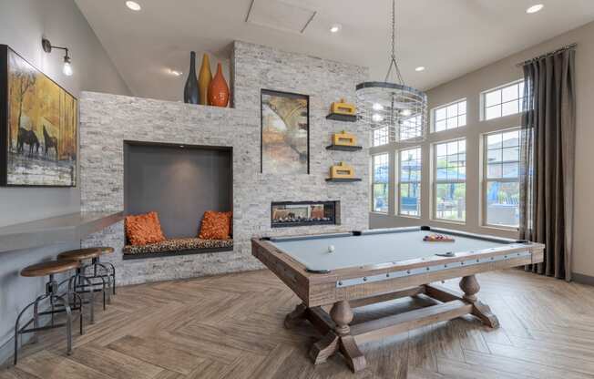 a game room with a pool table and a fireplace