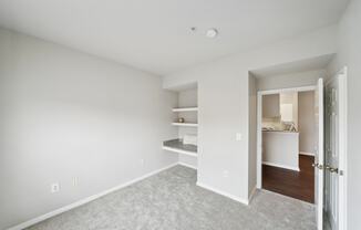 a bedroom with a closet and a door to a bathroom
