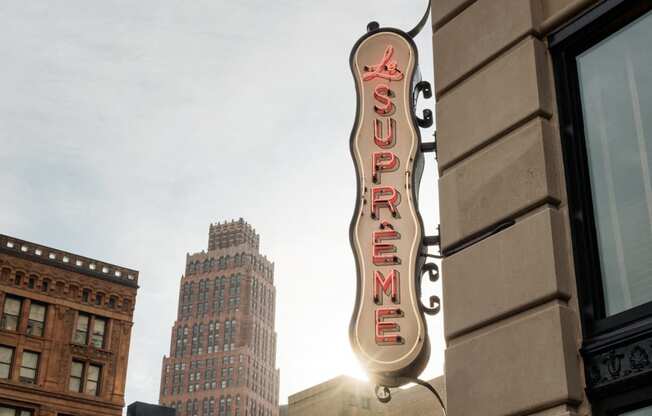 a neon sign on the side of a building in the cityat Book Tower, Detroit, Michigan