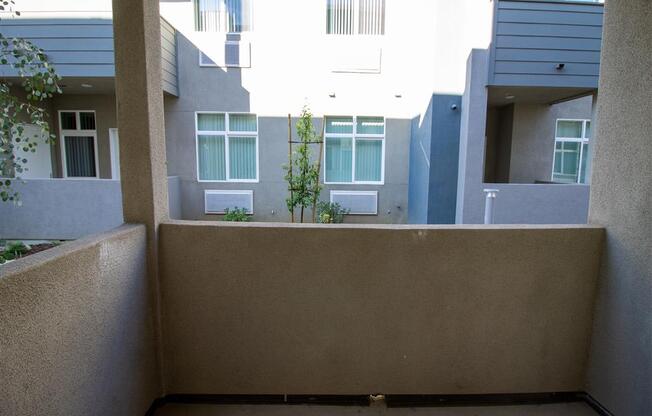 an empty balcony with an apartment building in the background at Loma Villas Apartments, San Bernardino California at Loma Villas Apartments, San Bernardino