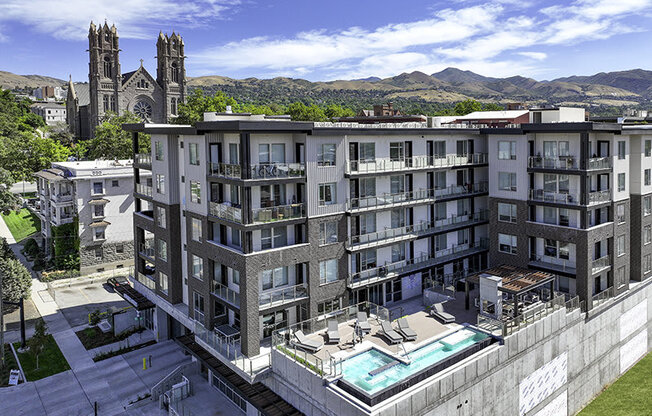 a drone shot of a pool and building at Lotus Republic Apartments for rent in Downtown Salt Lake City, Utah