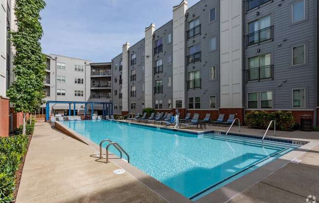 a swimming pool in front of an apartment building