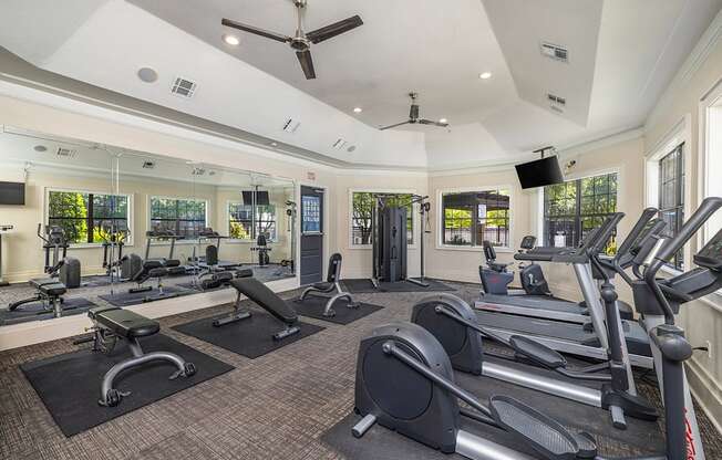 A gym with treadmills, elliptical machines, and other exercise equipment.