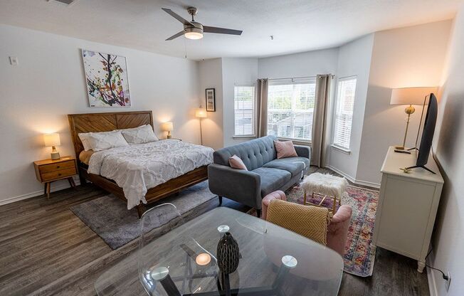 a bedroom with a bed and a couch