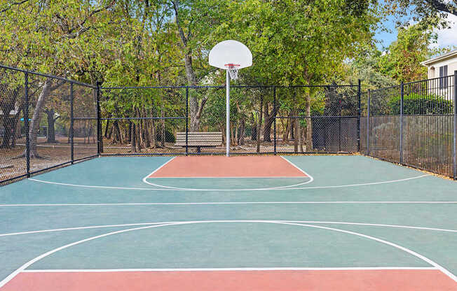 A basketball court with a net and a basketball hoop.