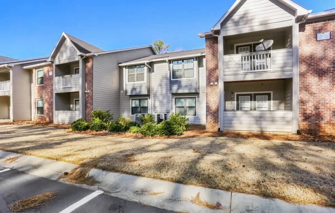 A row of apartment buildings with a clear blue sky above them.