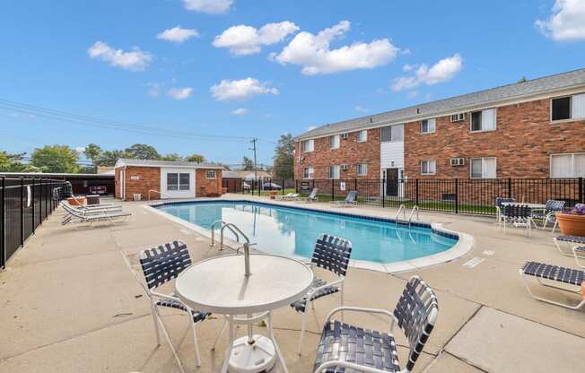 our apartments offer a swimming pool with chairs and tables