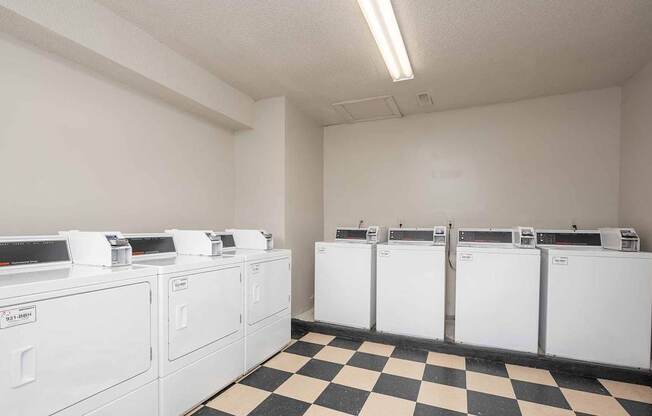A row of washing machines in a laundromat.