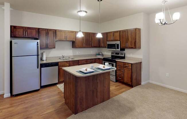 A kitchen with wooden cabinets and a white fridge.at Cypress Court, St Cloud