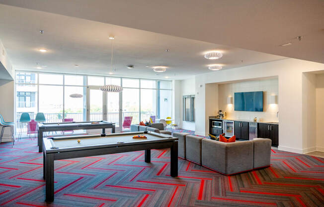 a large living room with a pool table and couches at 20 Midtown, Birmingham, Alabama