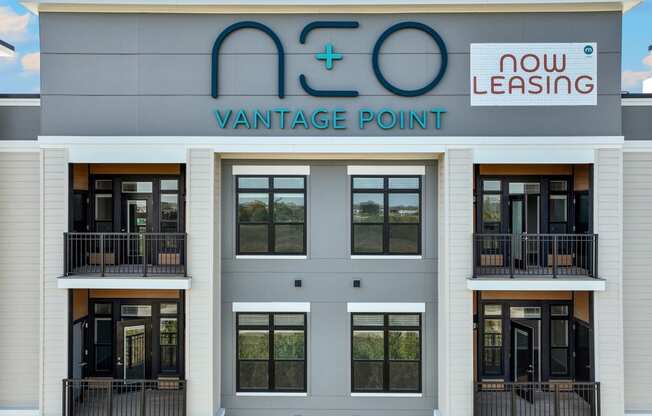the front of a building with windows and a sign for vantage point