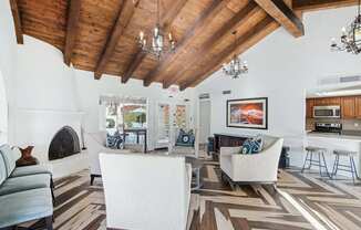 A living room with a fireplace and a painting on the wall.