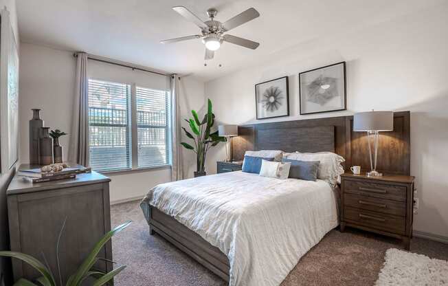 a bedroom with a bed and a ceiling fan